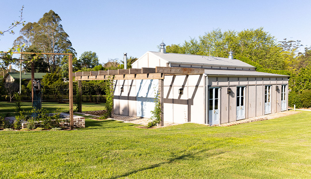 Gold Coast's Elegant barn with custom outdoor sconce lighting.