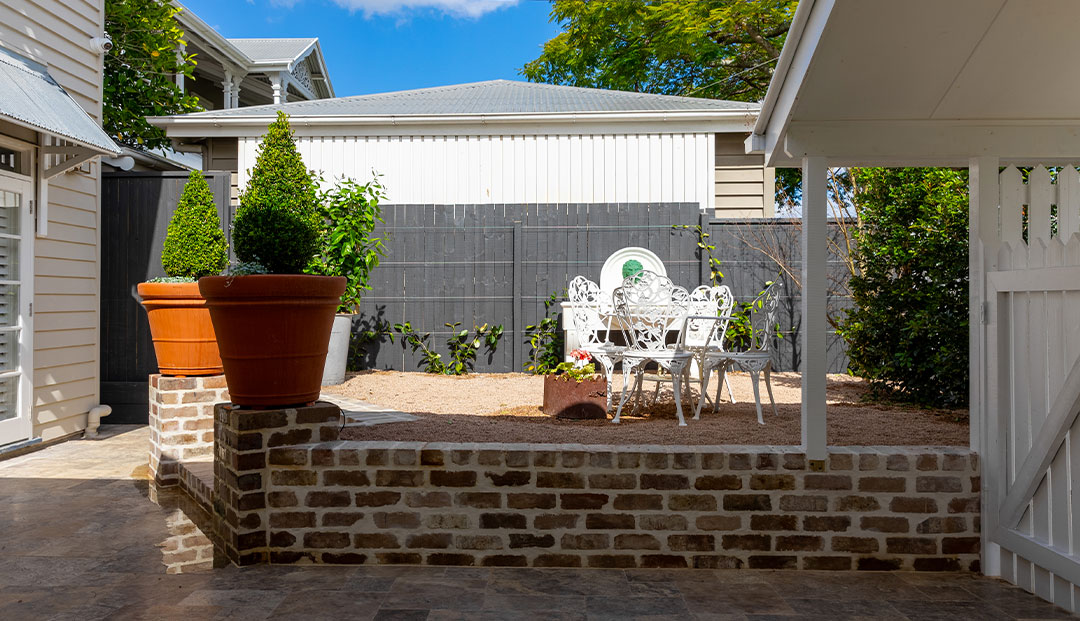 Private patio with vintage white furniture in Brisbane.