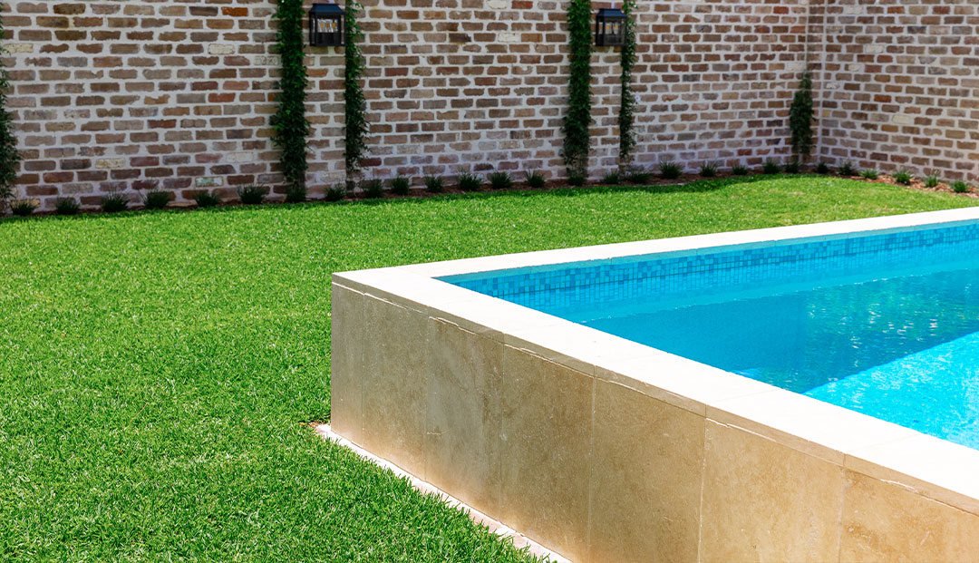 Modern pool with travertine tiles in Harding Street, Brisbane.