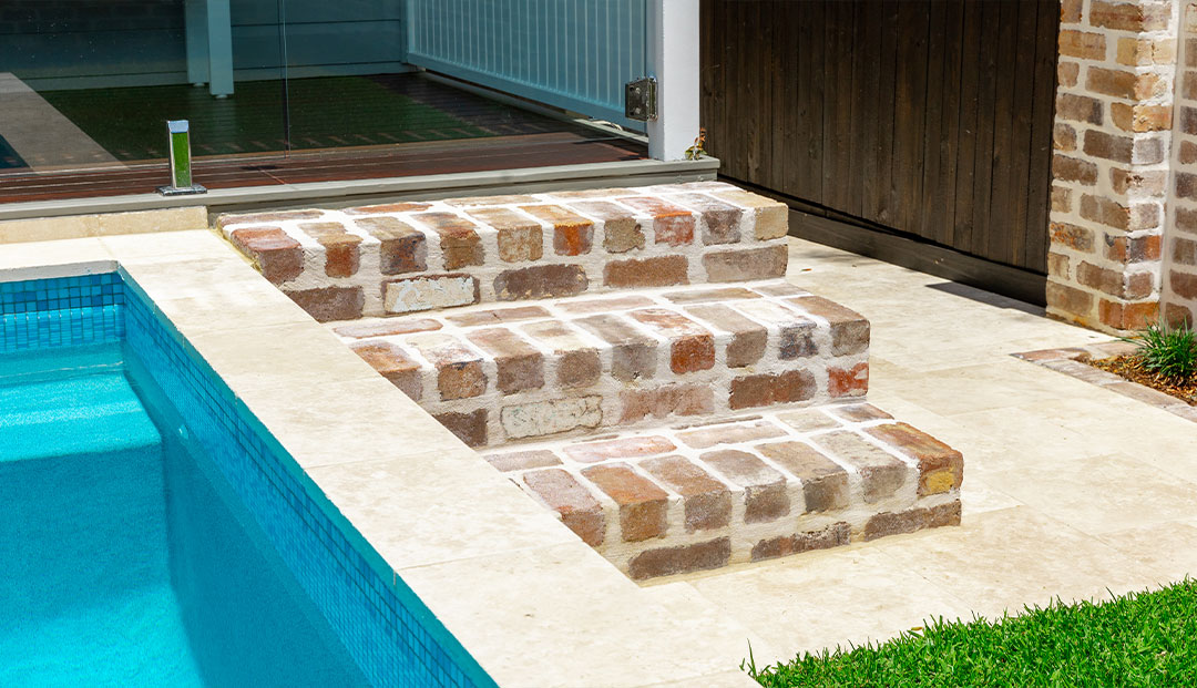 Recycled brick steps leading to a pool in Harding Street, Brisbane.