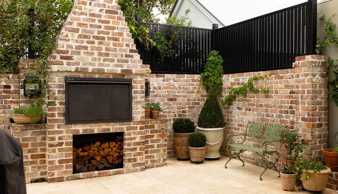 Recycled Brick fireplace,pizza oven and garden pots in an outdoor area at Hazelmere Parade, Brisbane.