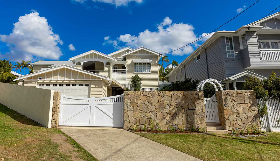 raditional Queenslander home with stone fence on Hipwood Street, Brisbane.